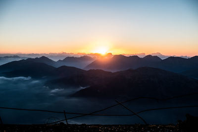 Scenic view of silhouette mountains against sky during sunset