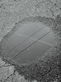 High angle view of puddle on road
