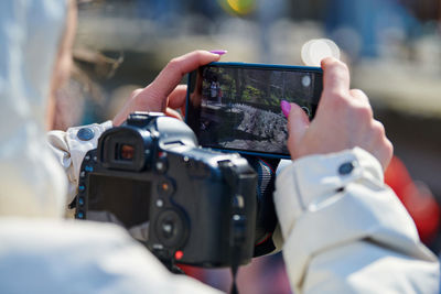 Midsection of man using mobile phone