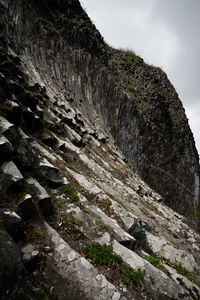 Low angle view of rock formation against sky