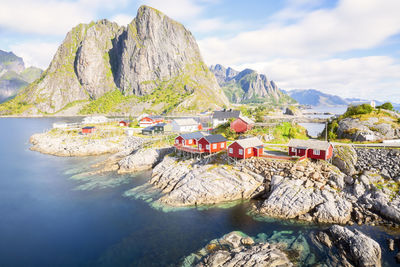 Scenic view of rocks by sea against sky