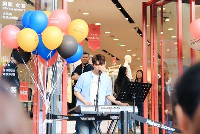 People standing on balloons at music concert