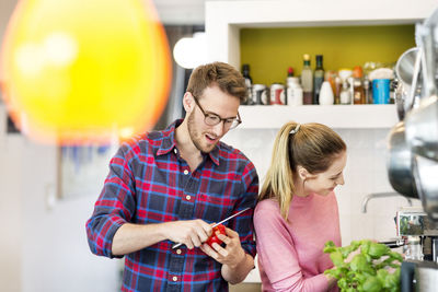 Young couple preparing healthy meal in kitchen