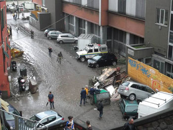 High angle view of vehicles on road along buildings