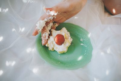 Close-up of hand holding cake