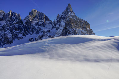 Snowcapped mountains against blue sky