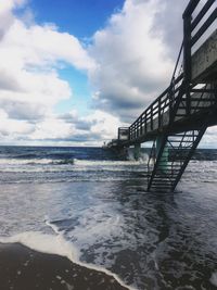 Pier over sea against sky