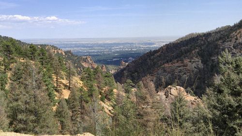 Scenic view of sea and mountains against sky