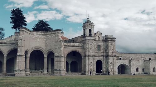 Historic building against cloudy sky