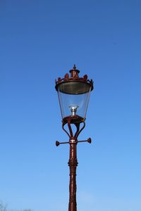 Low angle view of street light against clear blue sky