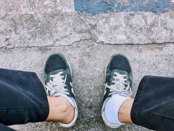 Low section of man standing on footpath