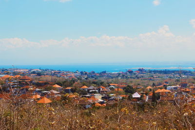 Aerial view of buildings on field against sky