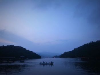 Scenic view of lake against sky at sunset