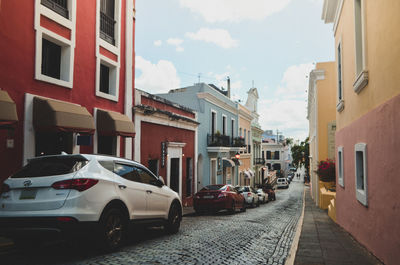 Cars on street amidst buildings in city