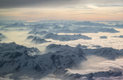 Scenic view of snow covered mountains against sky