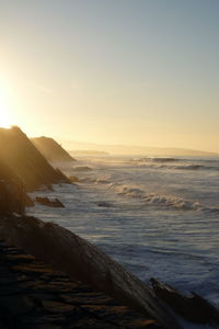 Scenic view of sea against clear sky during sunset