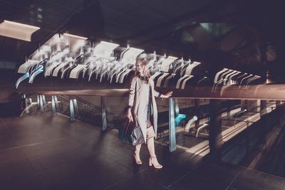 Young woman standing on footbridge at night