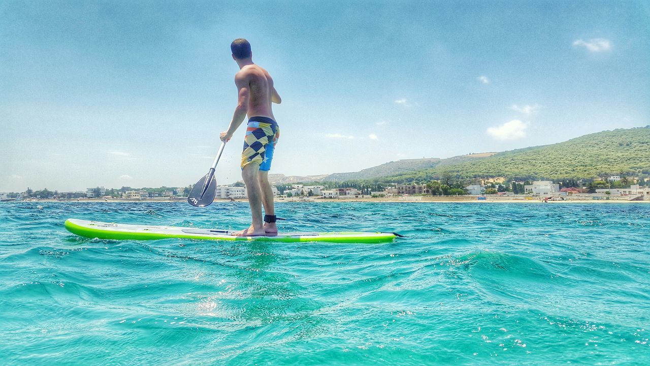 water, blue, sky, sea, leisure activity, tranquility, lifestyles, waterfront, tranquil scene, scenics, nature, beauty in nature, rippled, vacations, nautical vessel, full length, day, sunlight