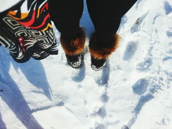 Low section of people standing on snow