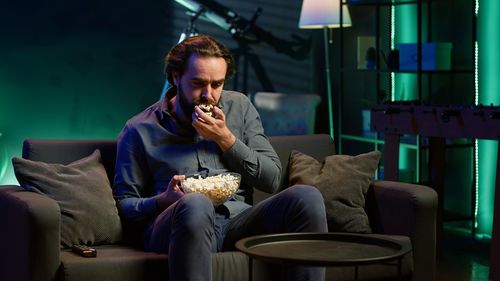 Young woman drinking coffee while sitting at restaurant