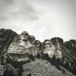 Low angle view of rock formation against sky