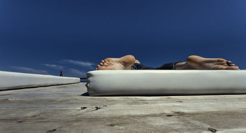 Low section of man lying on mattress