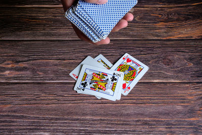 Cropped hand playing poker at table