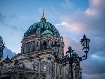 Low angle view of building against cloudy sky