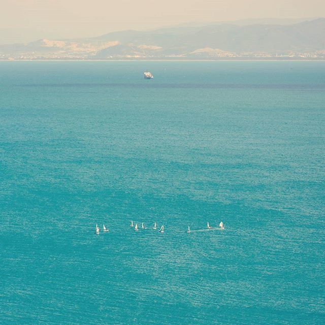 sea, water, nautical vessel, waterfront, transportation, mode of transport, boat, horizon over water, blue, tranquil scene, tranquility, scenics, beauty in nature, nature, seascape, sailing, rippled, sky, idyllic, travel