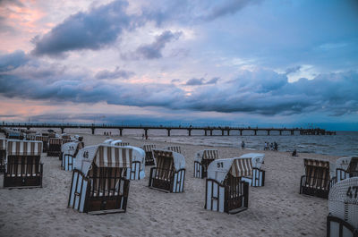 Empty beach against cloudy sky