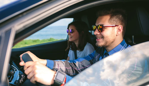 Young couple driving car