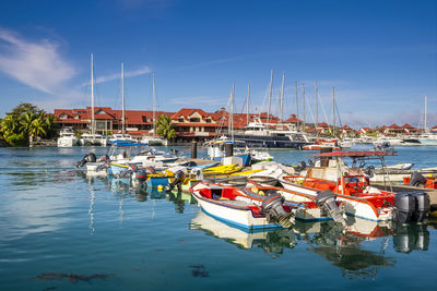 Sailboats moored in harbor eden island, seychelles 