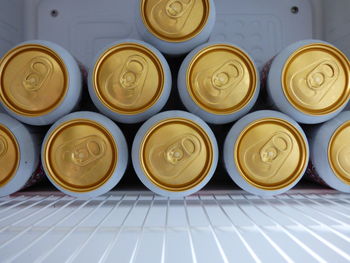 Cans of lager stacked up in drinks chiller