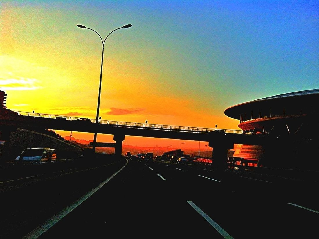 sunset, sky, built structure, silhouette, orange color, architecture, transportation, street light, railing, the way forward, dusk, building exterior, connection, road, bridge - man made structure, outdoors, copy space, nature, no people, street