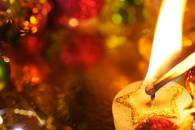 Close-up of lit christmas candle