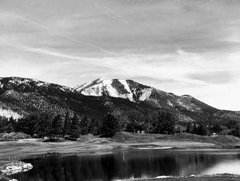 Scenic view of lake and mountains against sky