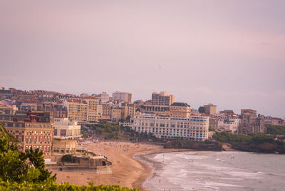 Buildings in city against clear sky