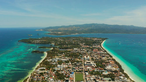 Costline of the tropical island of boracay with sandy beaches and hotels from above. 