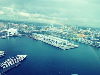 High angle view of city by river against sky