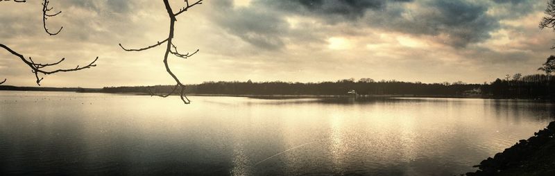 Scenic view of lake against cloudy sky