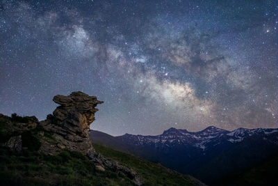 Scenic view of mountains against sky at night