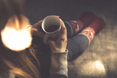 Woman having coffee at home
