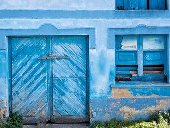 Closed blue door of ancient building