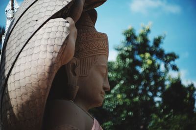 Close-up of buddha statue against trees