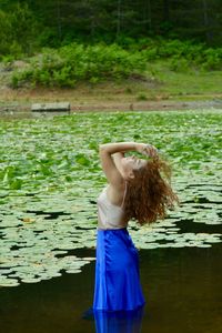 Side view of woman standing in lake