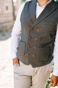 Midsection of man standing at beach