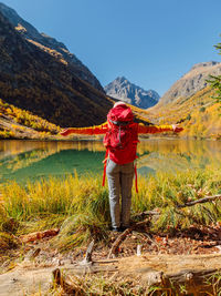 Rear view of woman standing against mountain