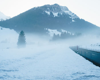 Scenic view of frozen lake against mountain range