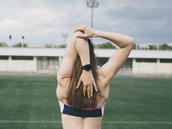 Young woman goes in for sports in the stadium