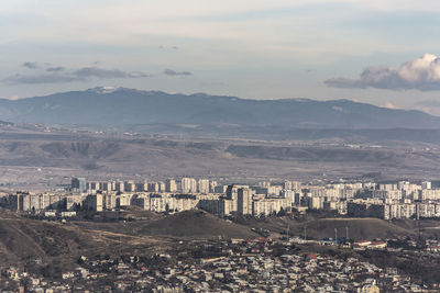 High angle view of city against cloudy sky